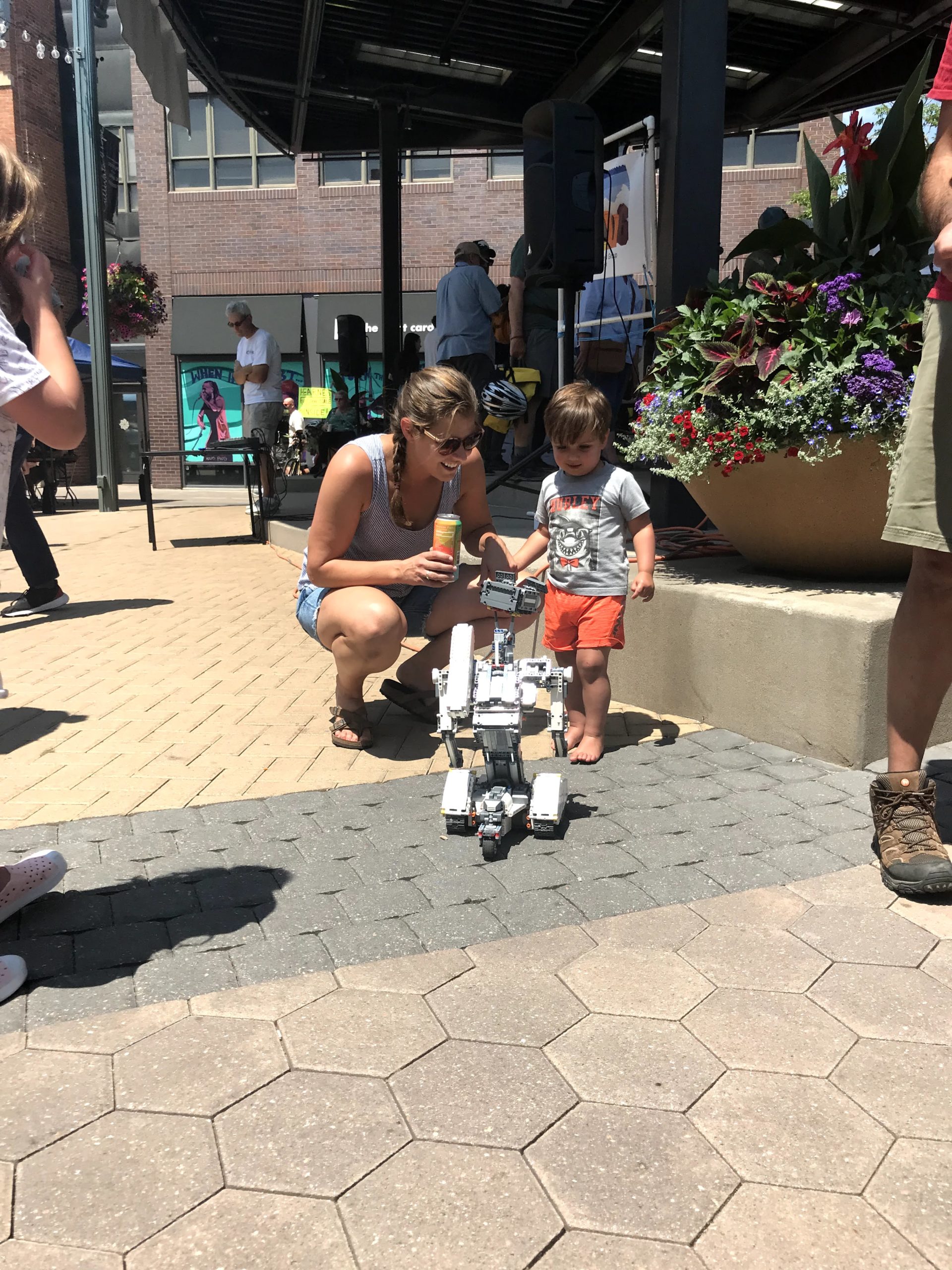 Mother and son inspecting a robot in Old Town Square
