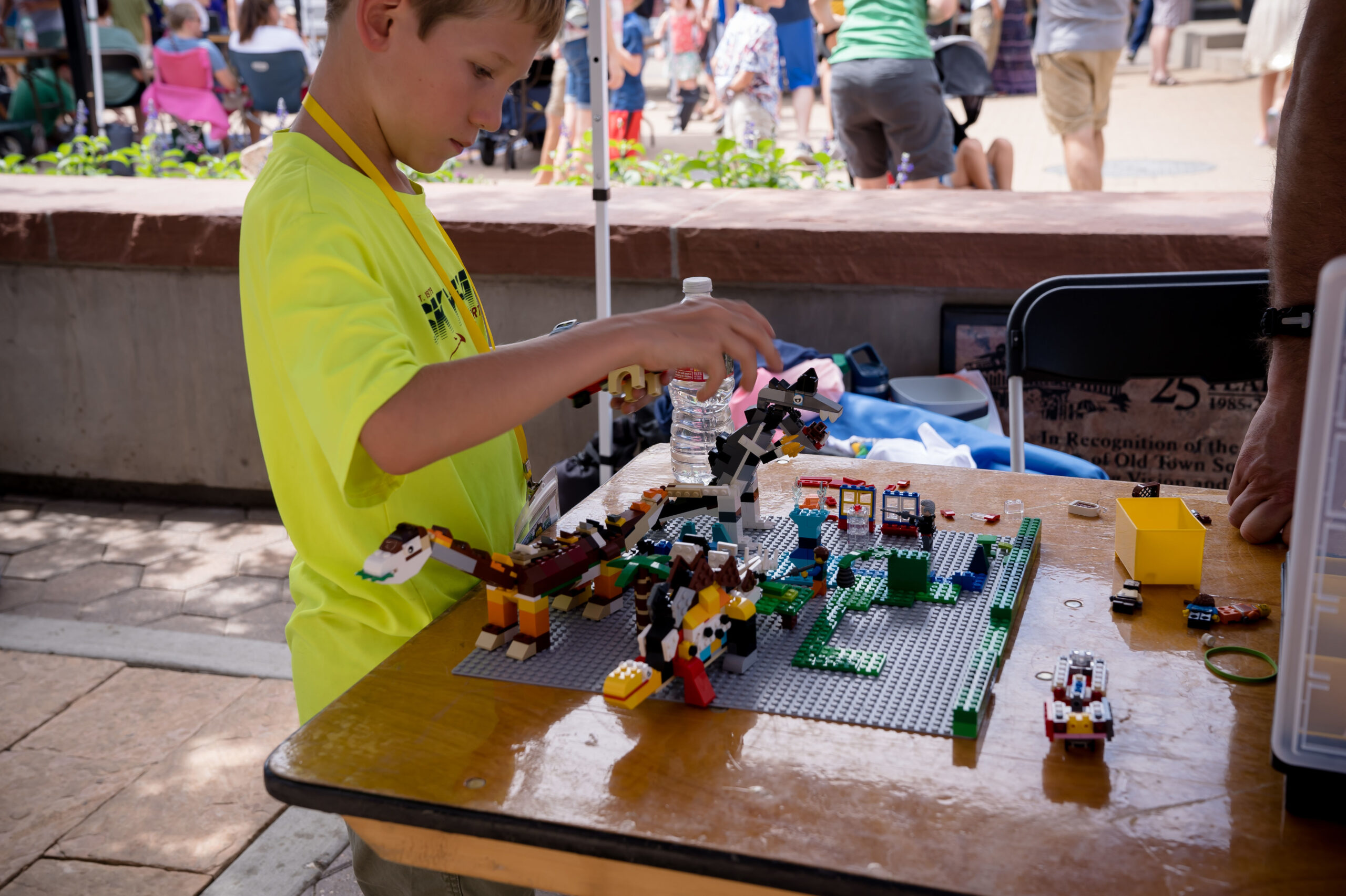 Child creating LEGO® model if dinosaurs