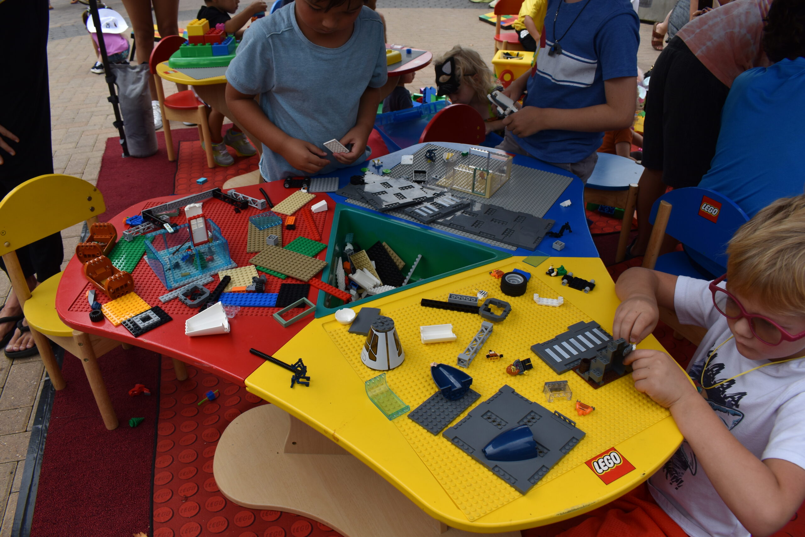 Children enjoying creating models of space ships and buildings from LEGOS®