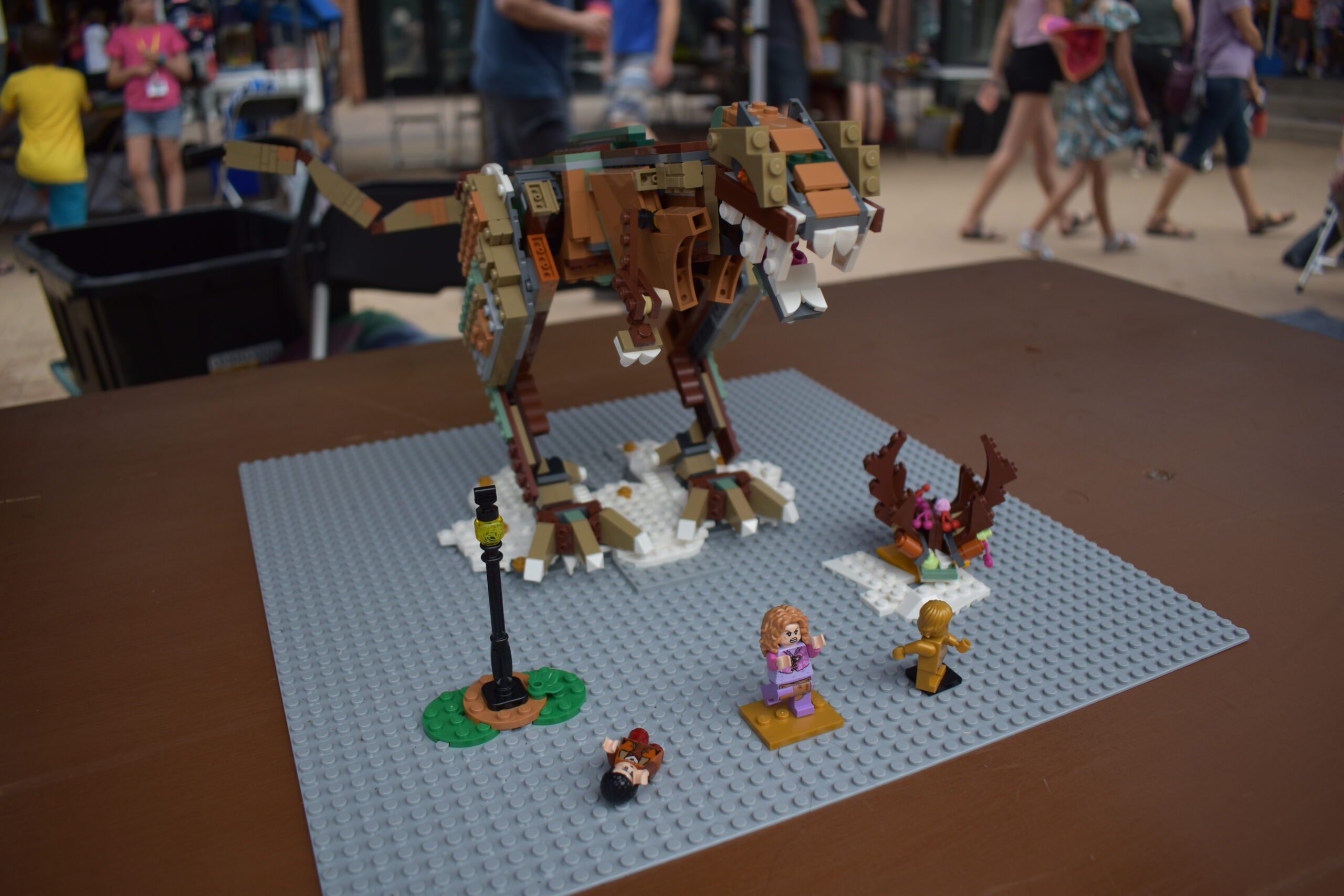 LEGO® creation of dinosaur and people running away