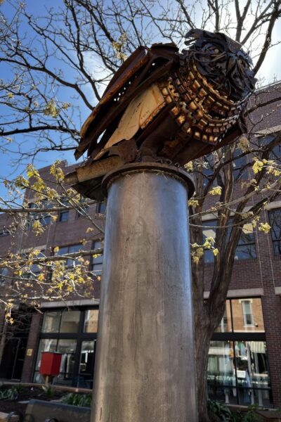 Owl perched on pedestal sculpture