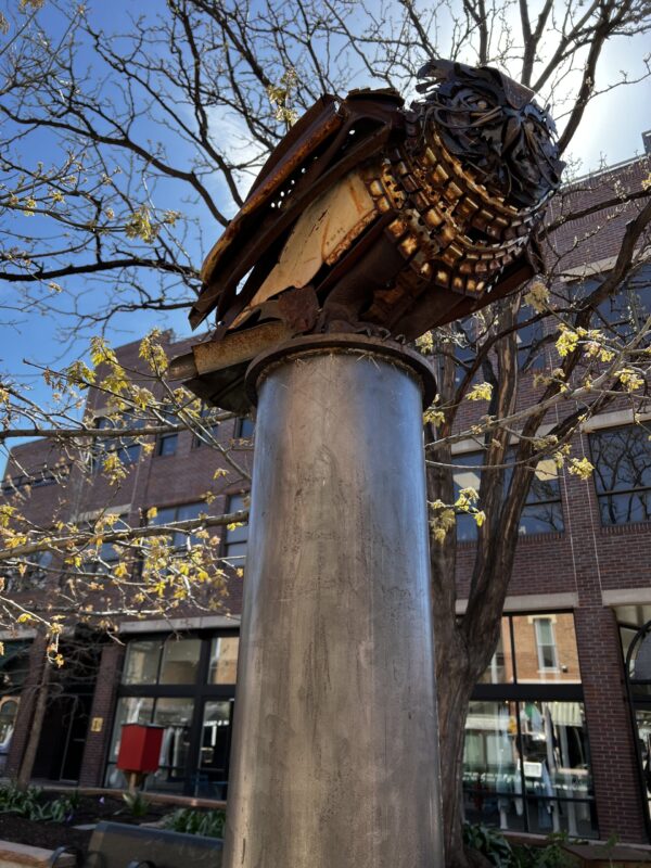 Owl perched on pedestal sculpture