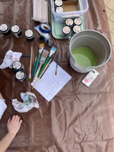 paint supplies and a bucket of green paint