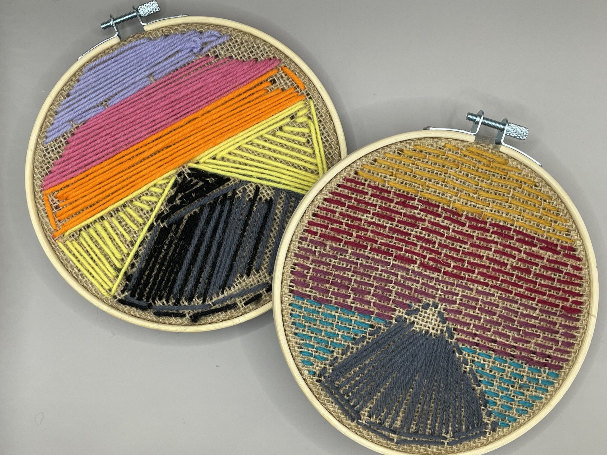 Two circle embroidery pieces with mountain patterns, one shows the back side, and the other is the front side.