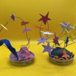 Two wire sculpture art, one with colorful stars on wires, and the other with sparkly hearts