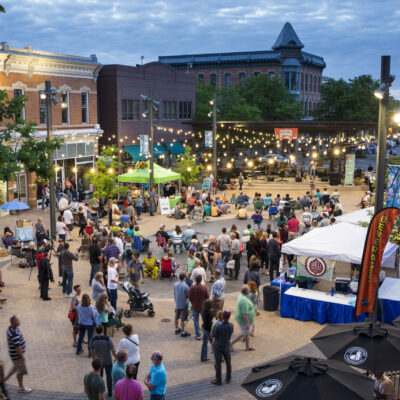 Event in Old Town Square with musicians on stage, several booths and a large crowd.