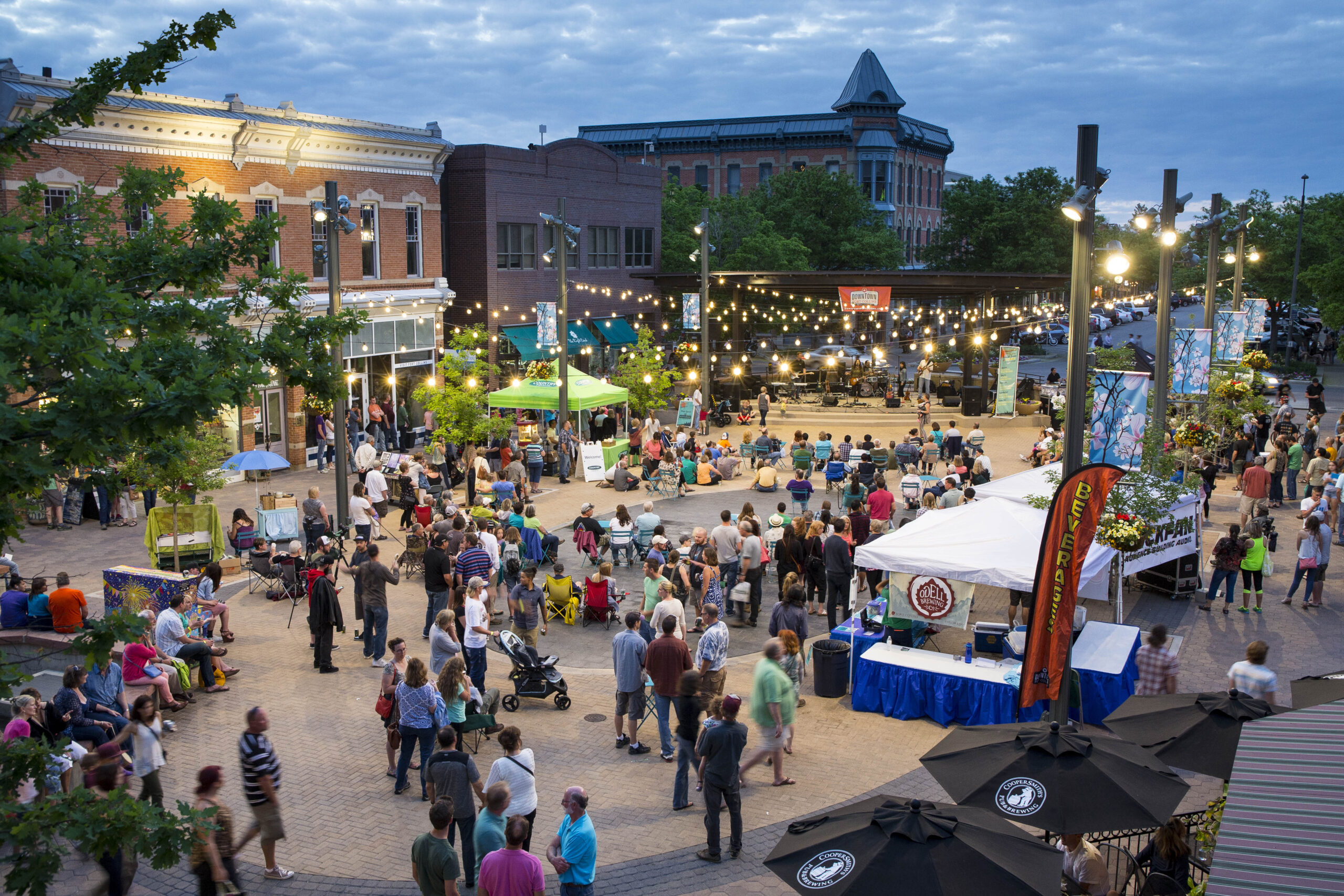 Event in Old Town Square with musicians on stage, several booths and a large crowd.