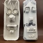 Egg carton crafts with lion face and person with mustache.