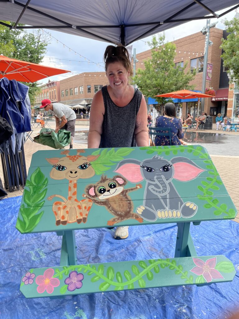 Adirondack 2 IMG_7272 Artist showing painted table in the plaza