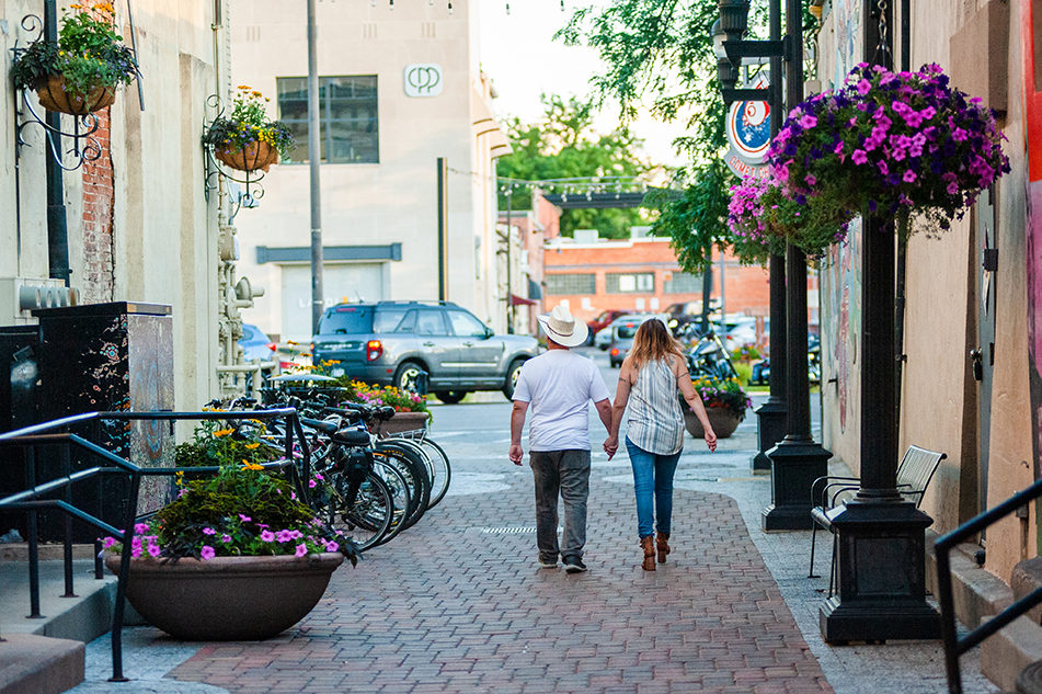 couple walking in alley in downtown fort collins during the summertime