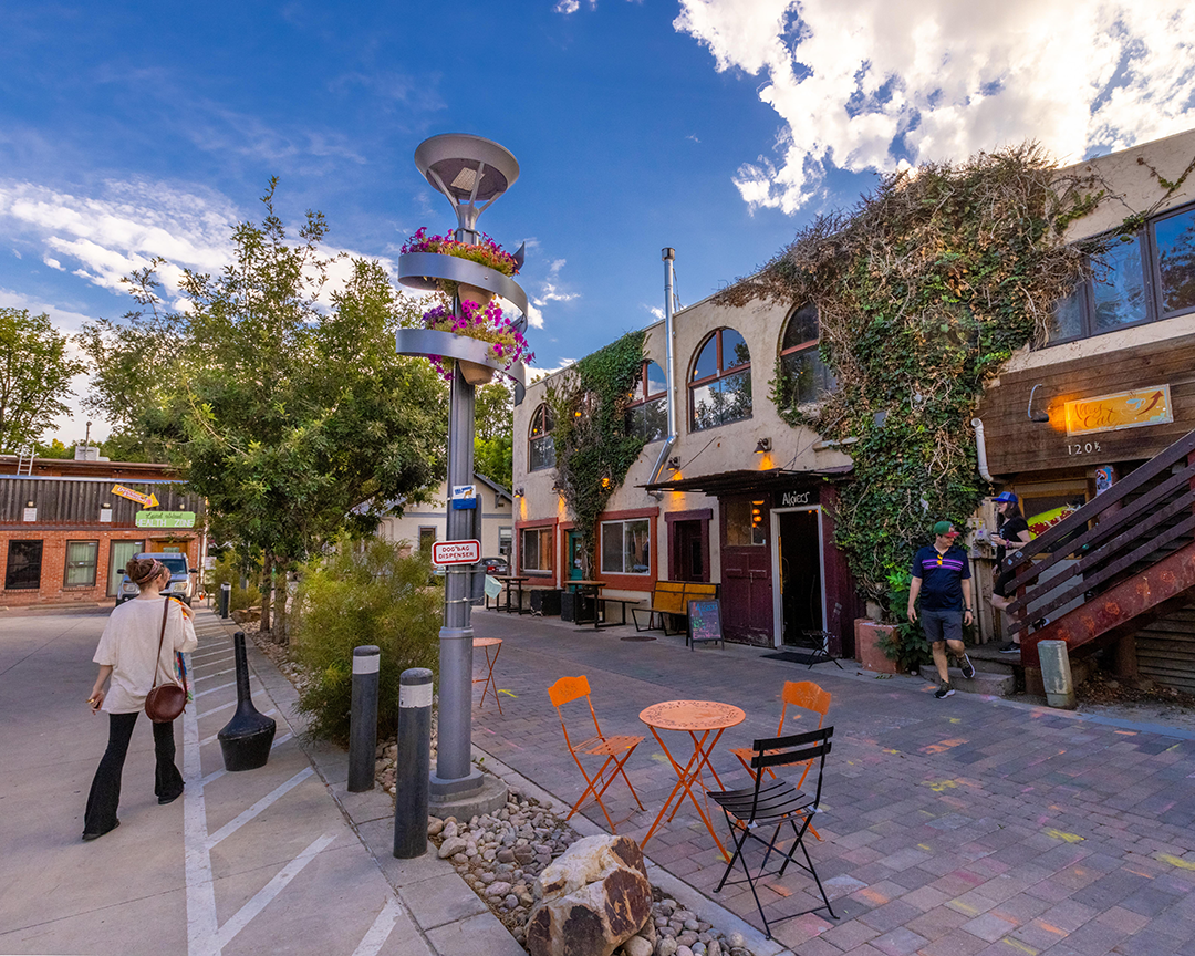 dalzell alley by alley cat with bistro tables and person walking